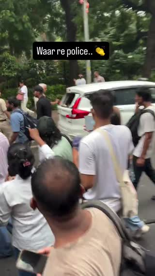 Police near their own vehicles, described by the source as staged damage